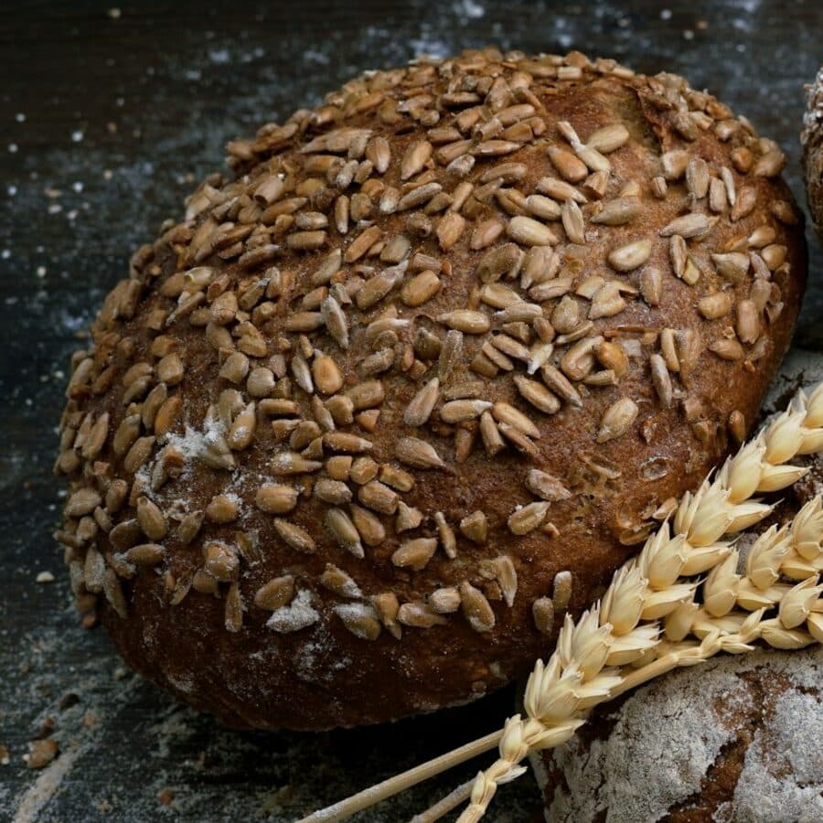 A round sourdough covered in sunflower seeds